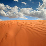 sand dunes with cloudy blue sky